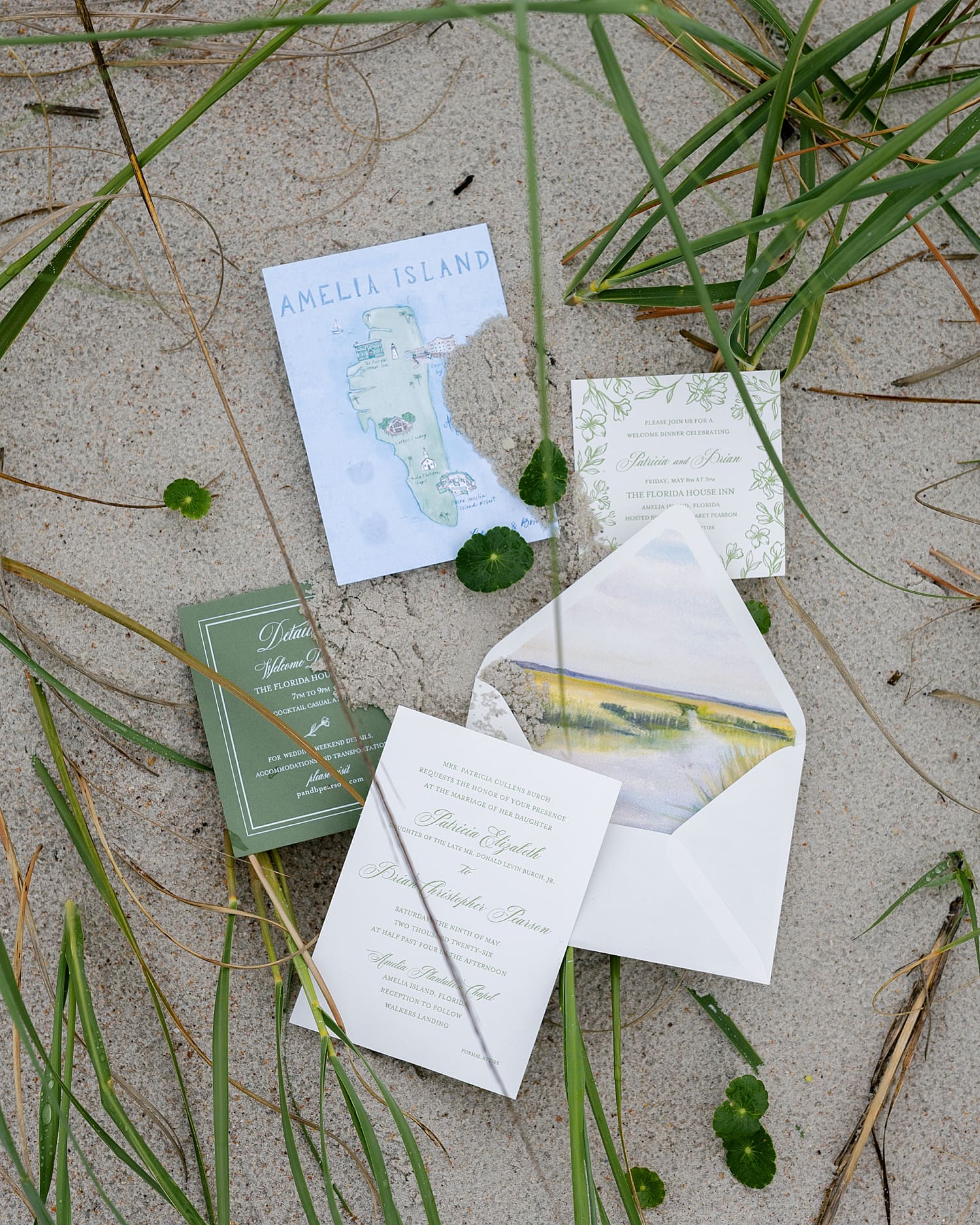 Wedding invitations in the sand on Amelia Island