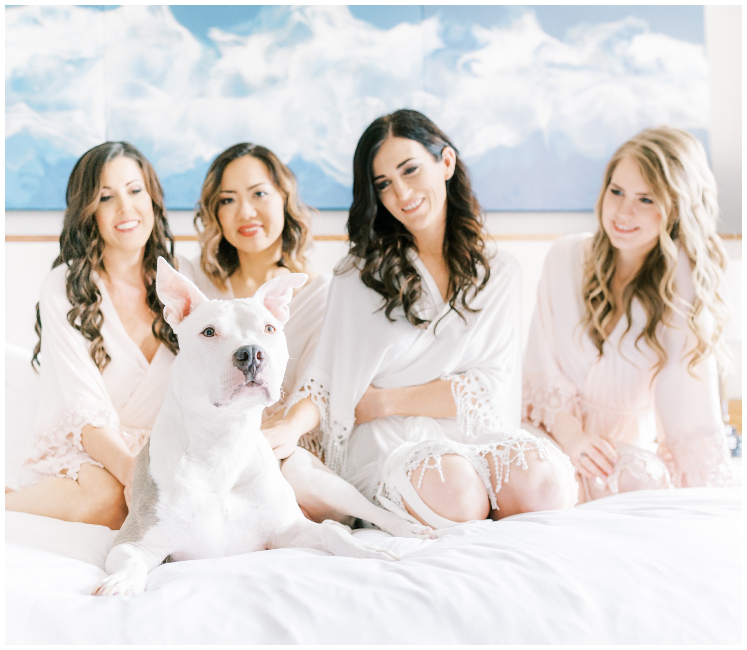 Bride with bridesmaids and dog getting ready