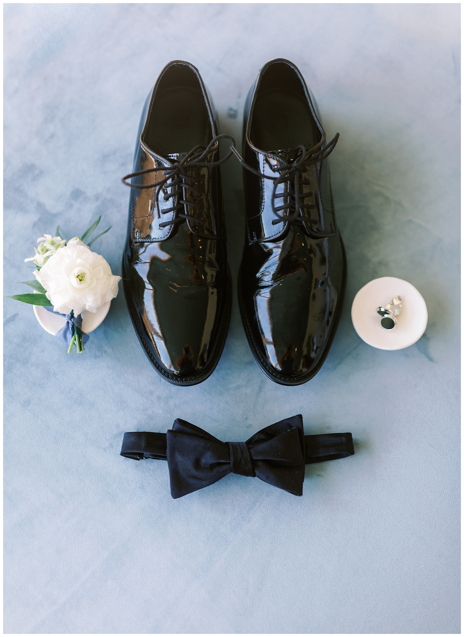 Groom details with shoes, bow tie and boutonnière