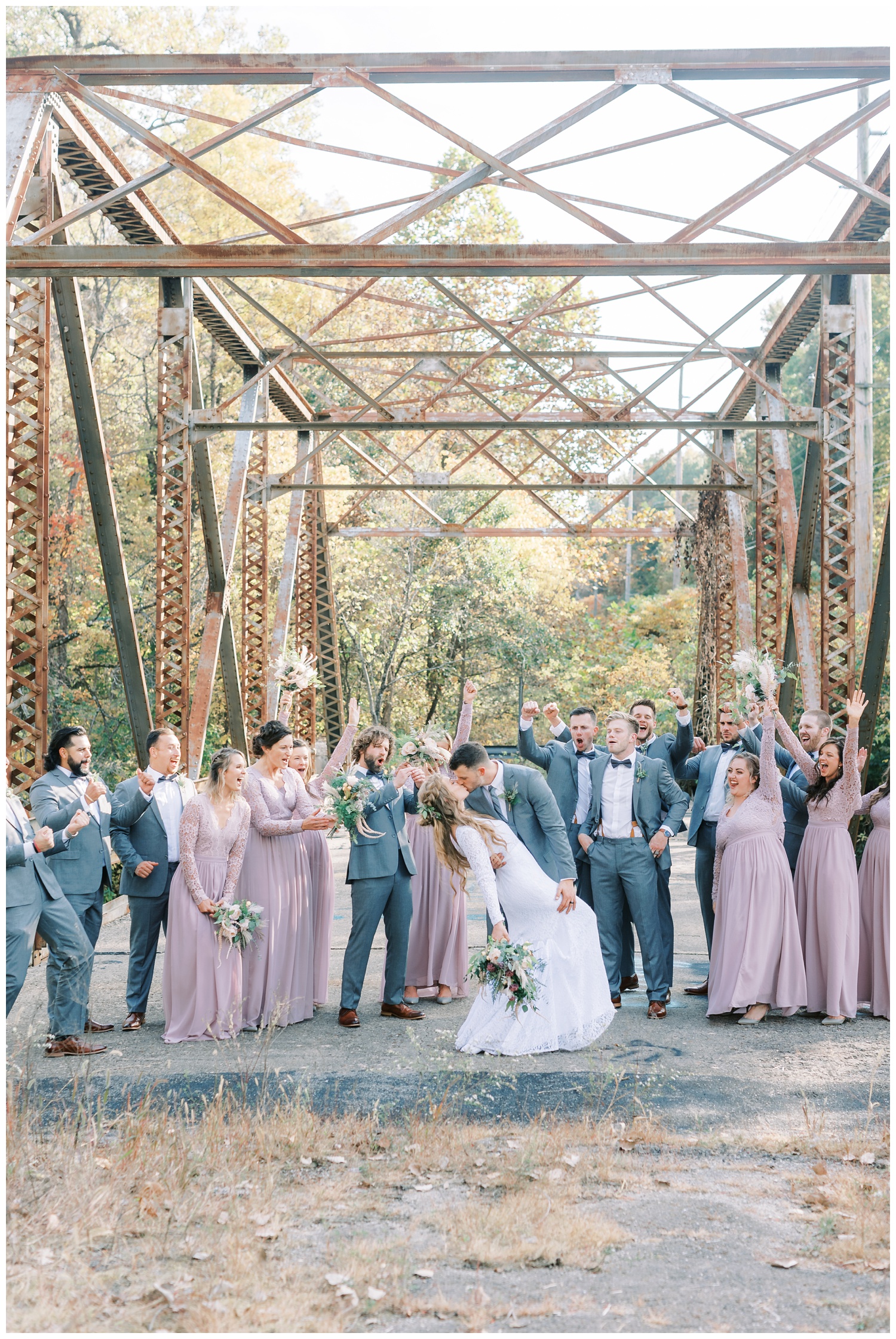 Bridal party on bridge in Illinois