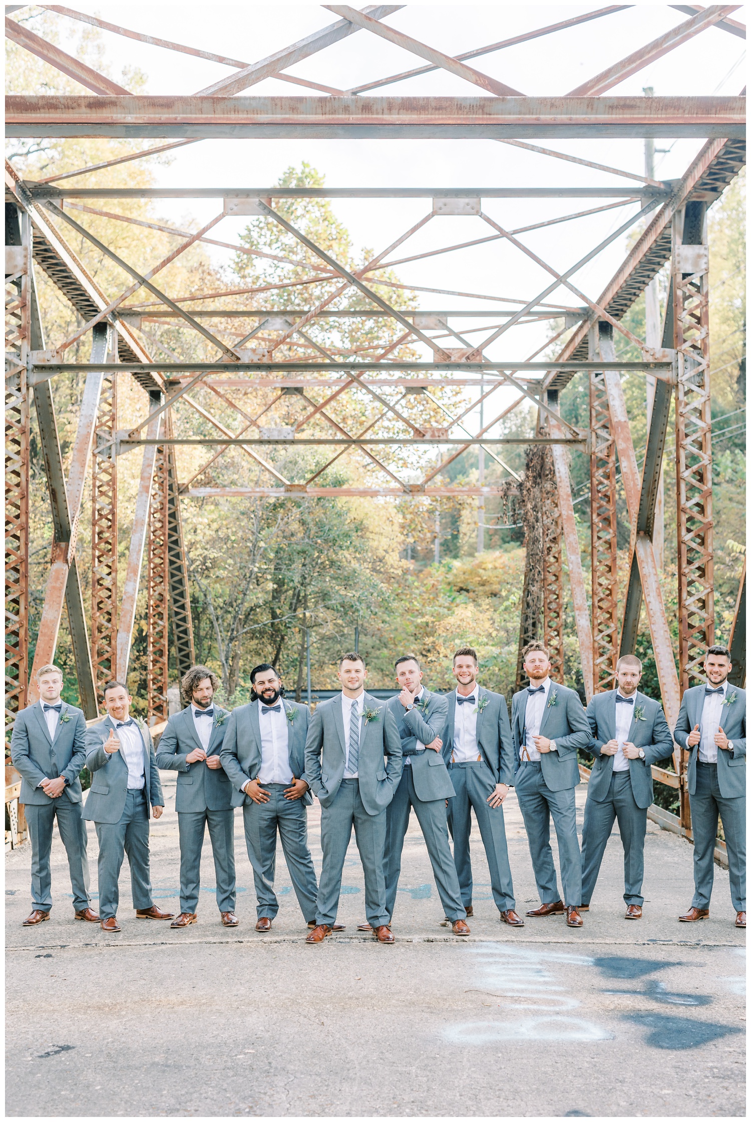 Groom with groomsmen on bridge in Illinois for wedding