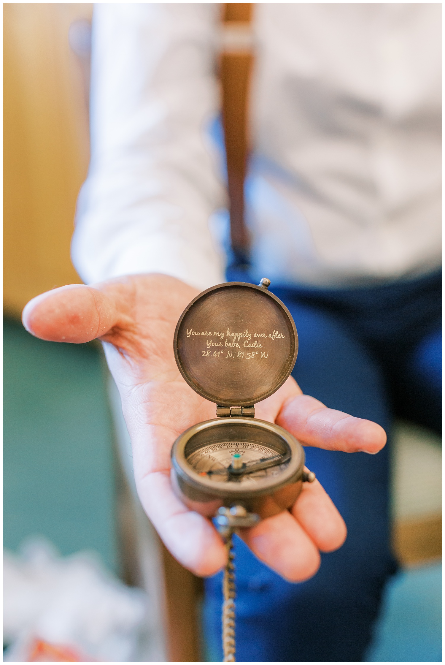 Groom being gifted a compass from his bride