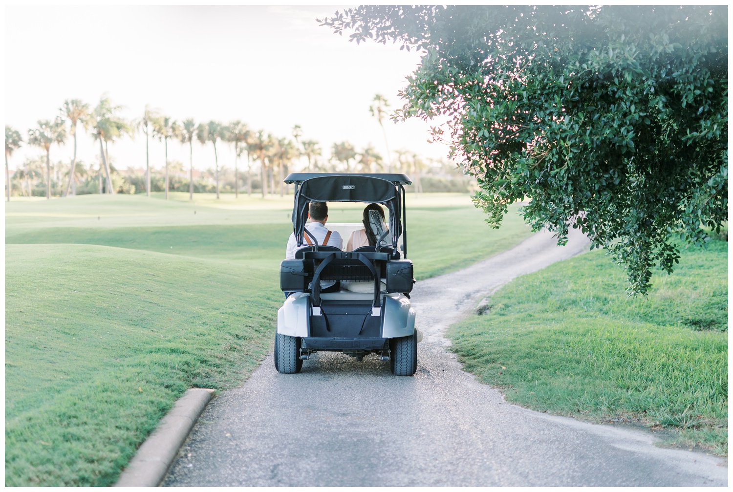 Bride and groom driving a golf cart
